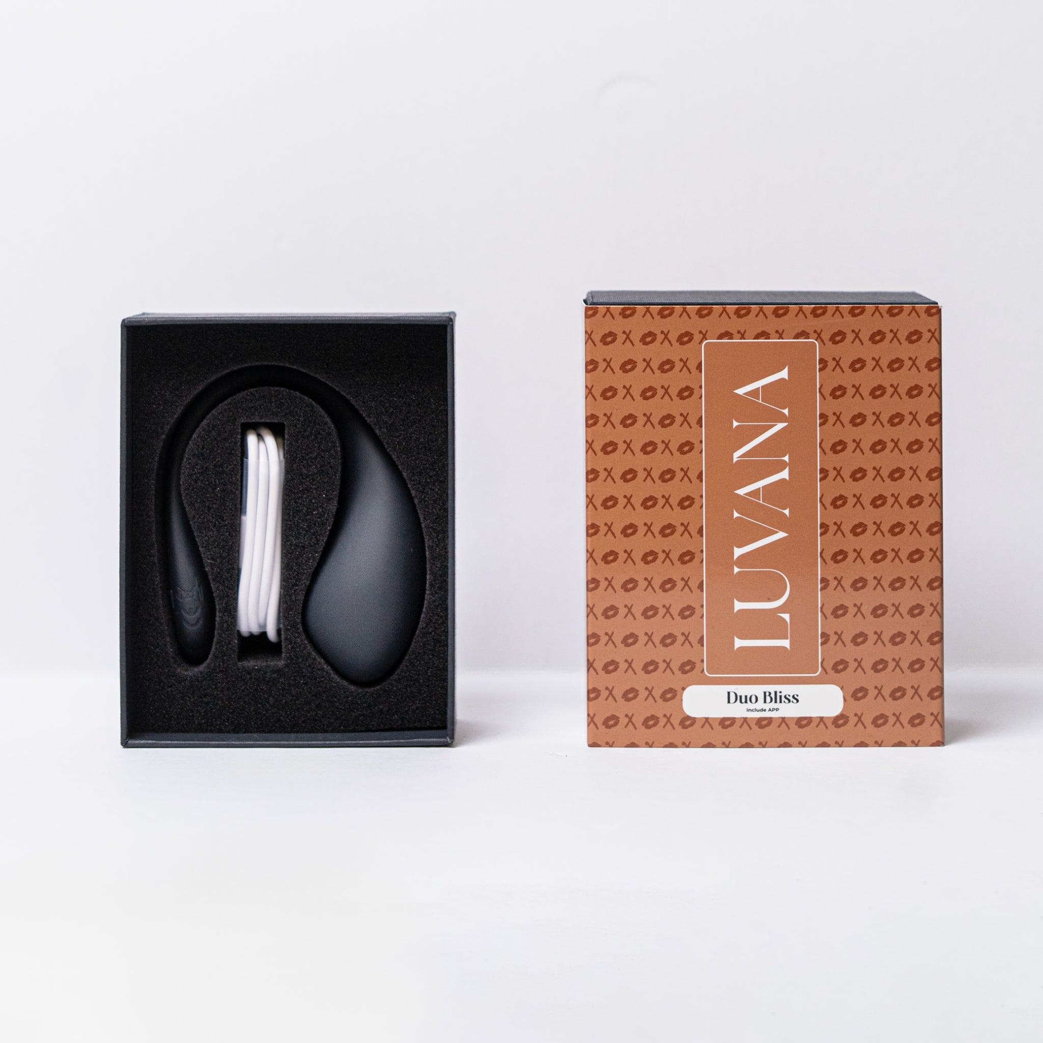 Luvana Duo Bliss unboxing photo with product in foam tray and USB charging cable next to branded retail box