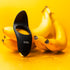 Luvana Black Stallion couples ring vibrator in black, photographed with bananas on a bright yellow background