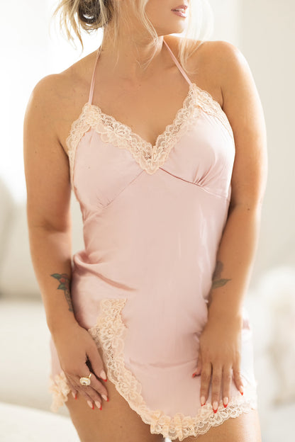 Blush satin slip lingerie close-up highlighting lace neckline and soft, lightweight satin fabric.