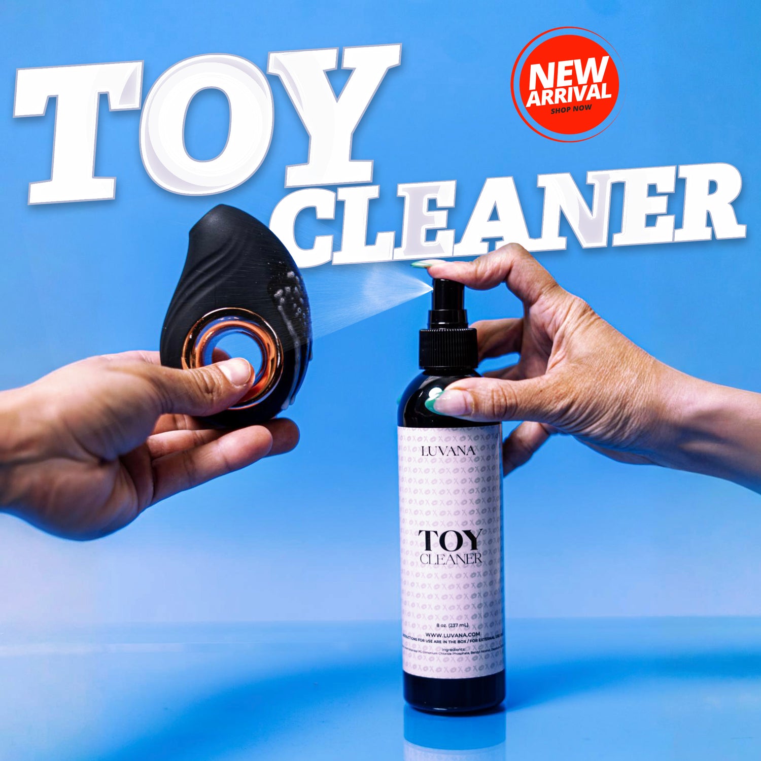 Hands spraying Luvana Toy Cleaner onto a black silicone toy on a blue background with “Toy Cleaner” text and a New Arrival badge.