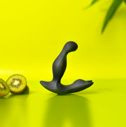 Luvana Knight Ryder silicone prostate massager on lime green set with whole kiwis and fruit slices.