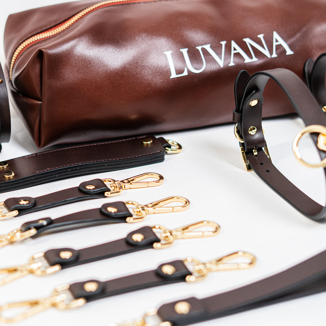Luvana Bondage Kit 11-piece full-grain leather restraint set in maroon with gold-tone hardware