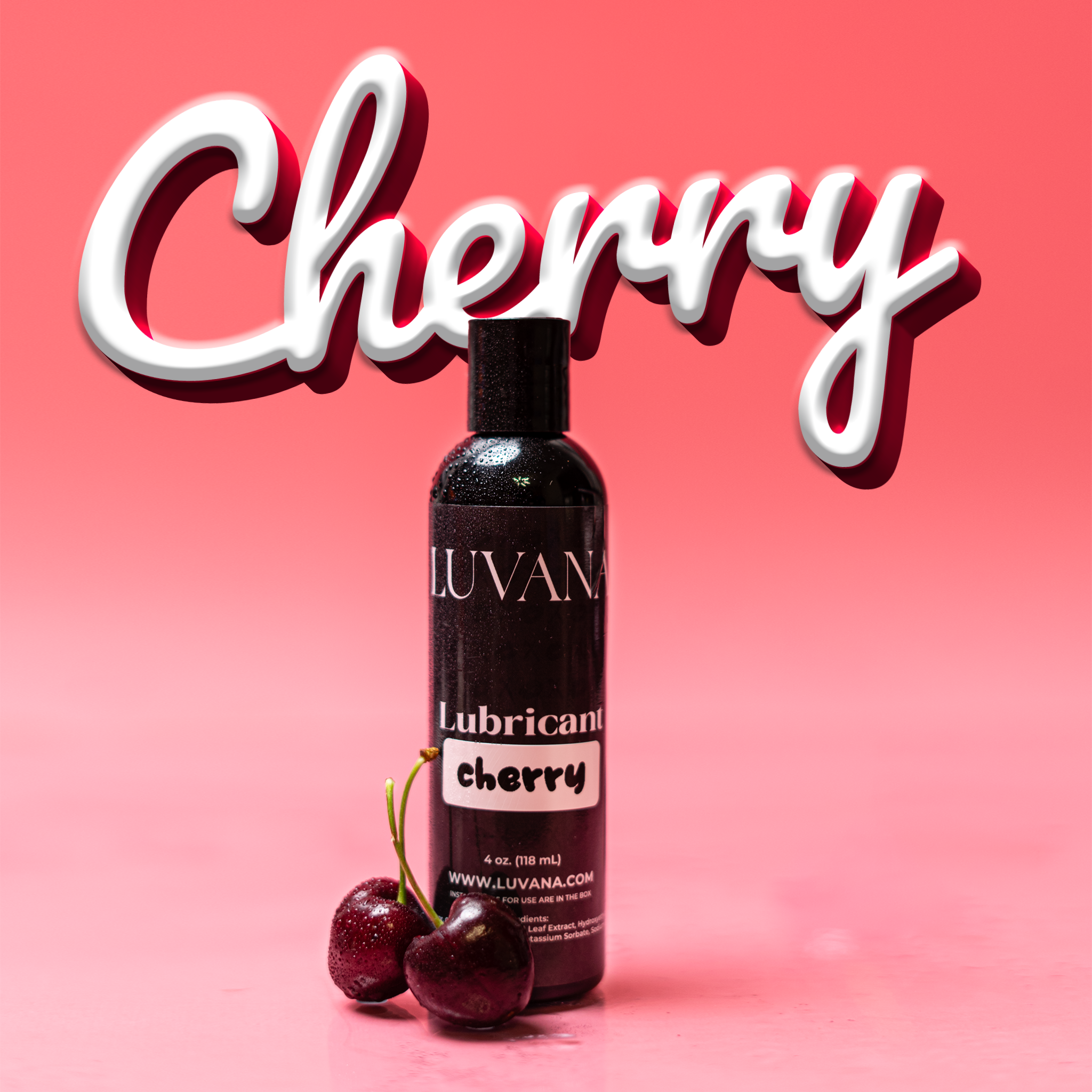 Luvana cherry flavored edible water-based lubricant bottle on a pink background with fresh cherries, 4 oz (118 mL).