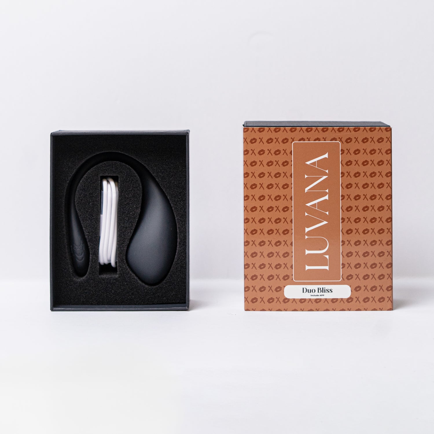 Luvana Duo Bliss unboxing photo with product in foam tray and USB charging cable next to branded retail box