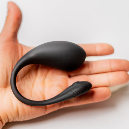 Luvana Duo Bliss wearable couples vibrator size in hand, black silicone device shown for scale and fit