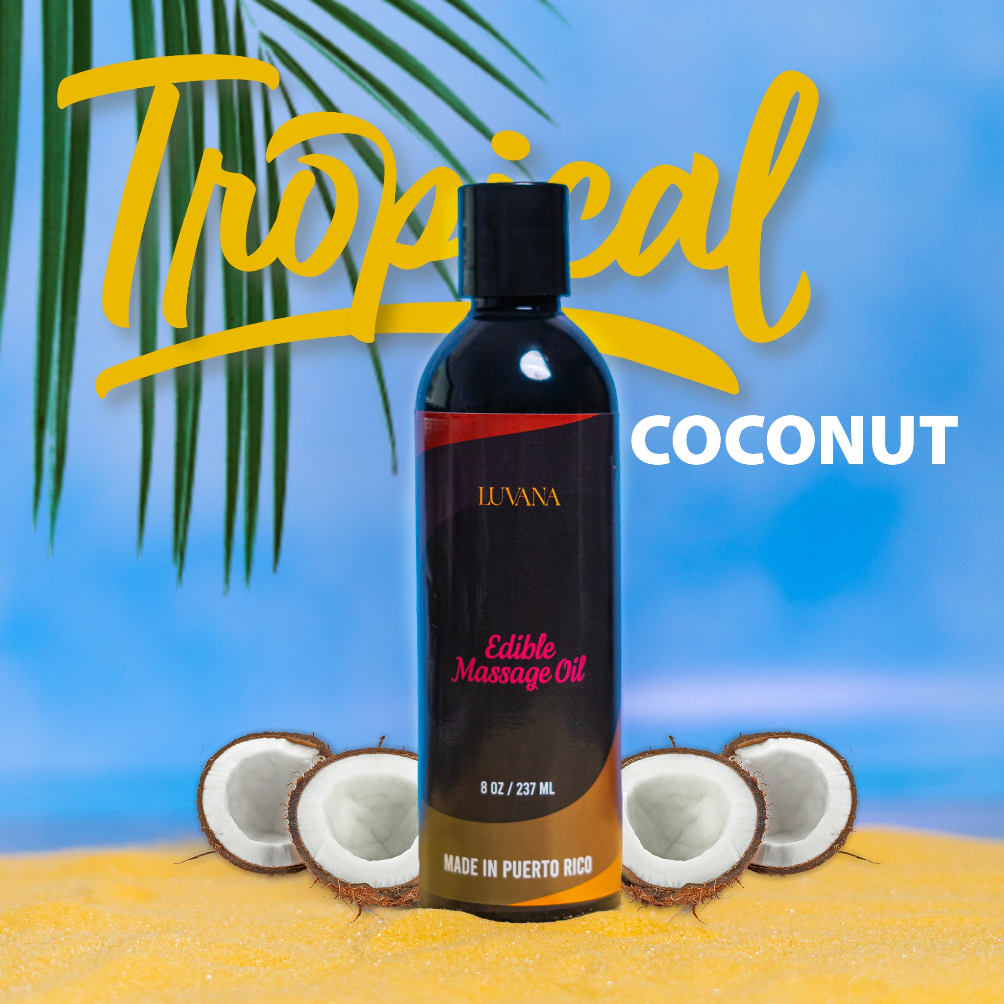 Luvana Edible Massage Oil in Tropical Coconut flavor standing on sand with coconut halves and a palm leaf, with “Tropical Coconut” text on a blue background.