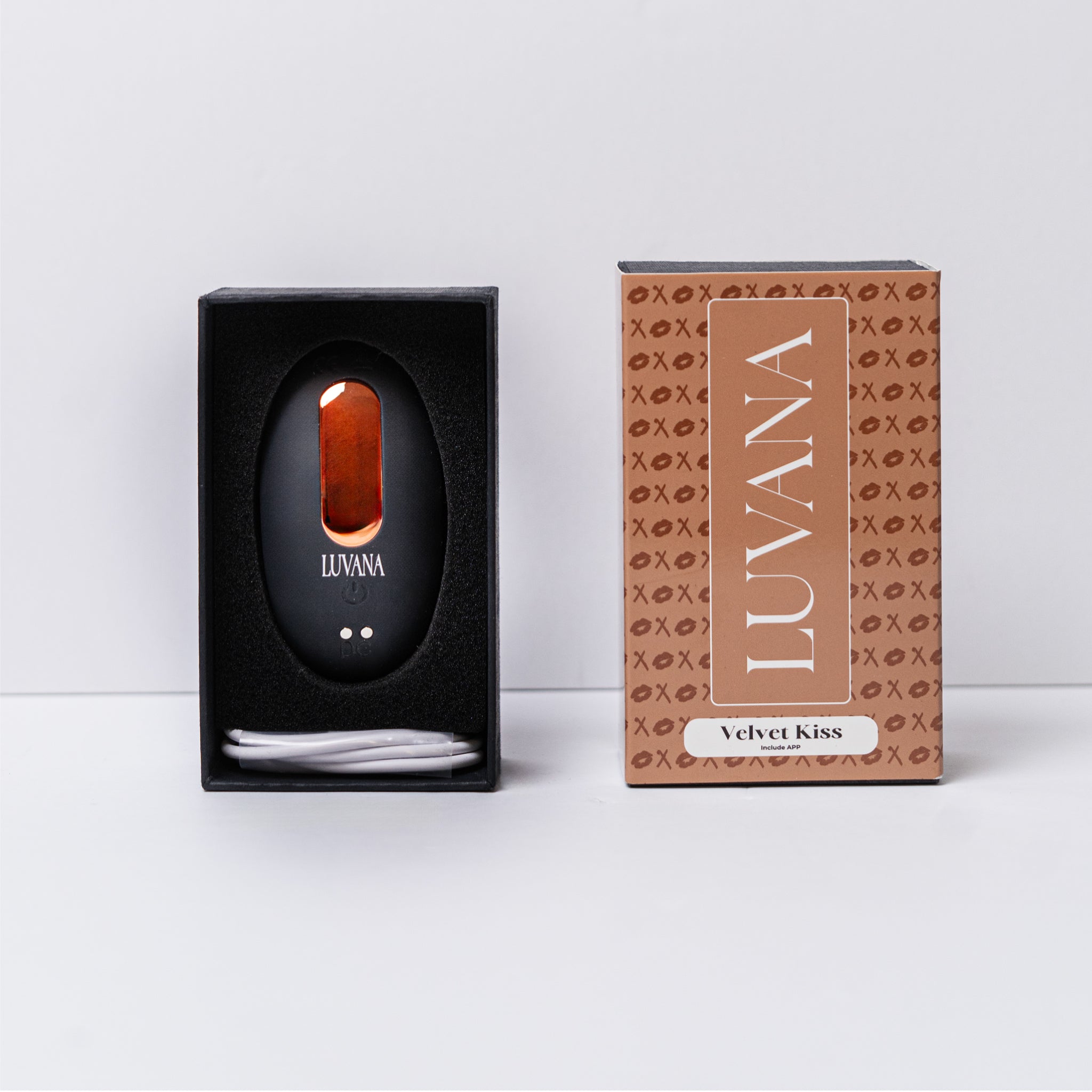 Luvana Velvet Kiss unboxing photo with vibrator and USB charging cable in foam tray next to branded Velvet Kiss retail box