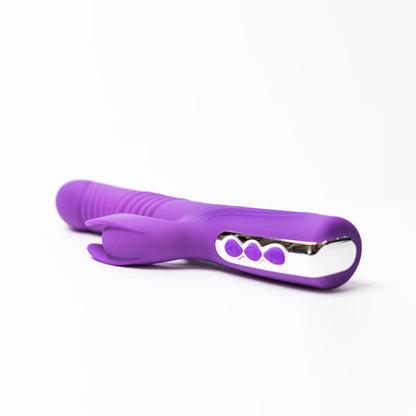 Luvana Thrust Bunny purple rabbit vibrator laying on white background, telescopic thrusting and clitoral stimulator design